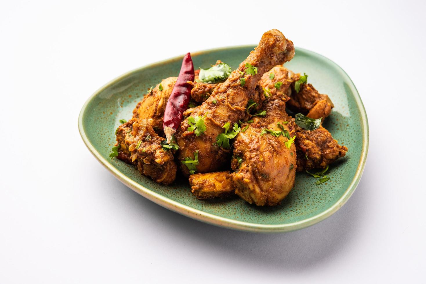 Sukha mutton or chicken, dry spicy Murgh or goat meat served in a plate or bowl photo