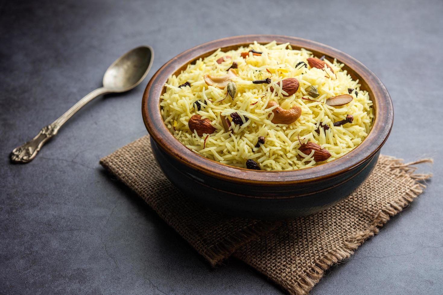 Kashmiri sweet modur pulao made of rice cooked with sugar, water flavored with Saffron and dry fruits photo