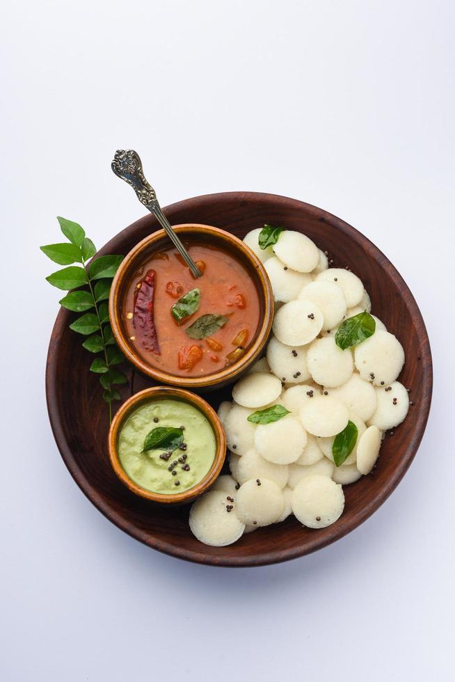 Mini idli is the smaller version of soft and spongy round shaped steamed regular rice idli, also known as button and cocktail idly photo