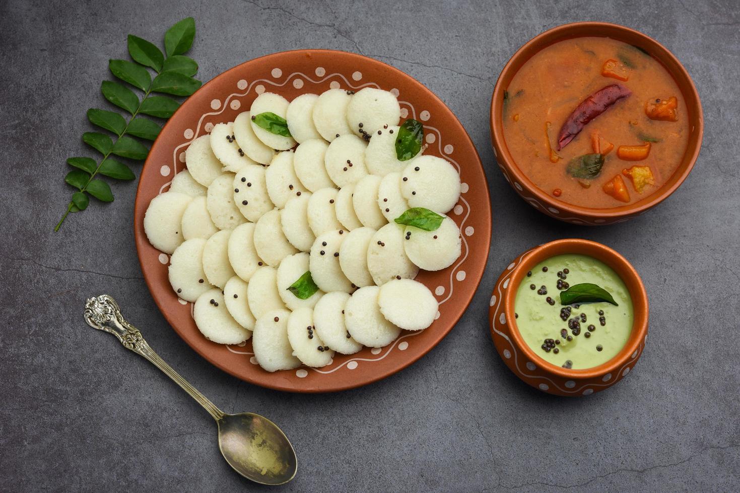 Mini idli is the smaller version of soft and spongy round shaped steamed regular rice idli, also known as button and cocktail idly photo