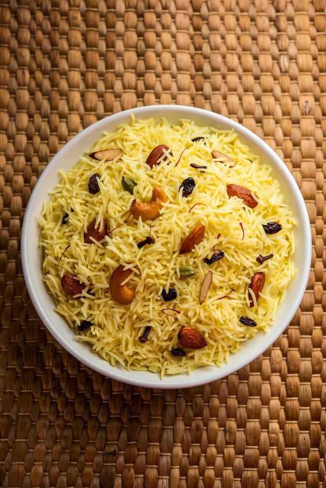 Kashmiri sweet modur pulao made of rice cooked with sugar, water flavored with Saffron and dry fruits photo