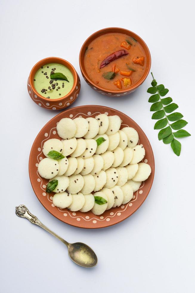 Mini idli is the smaller version of soft and spongy round shaped steamed regular rice idli, also known as button and cocktail idly photo