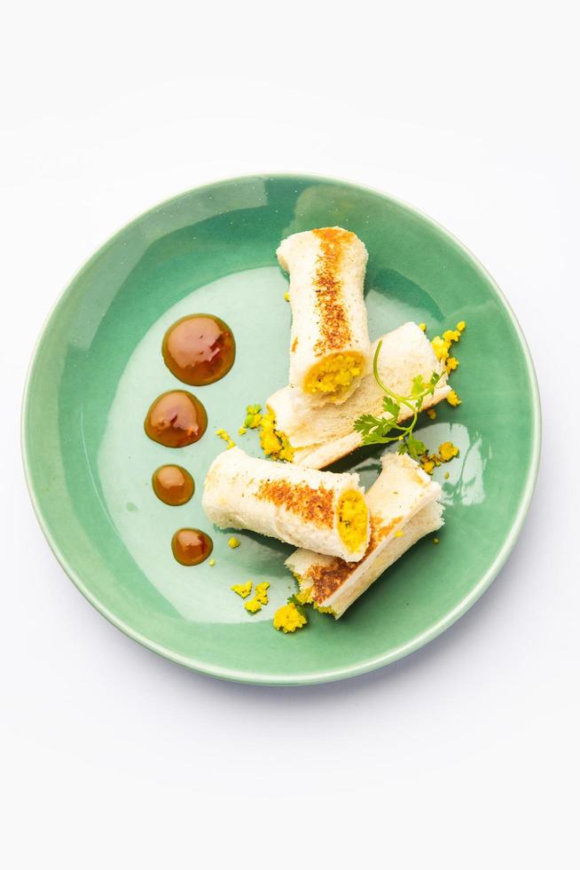 Indian paneer bread roll made using spiced grated cottage cheese mixed with spices, rolled and baked photo