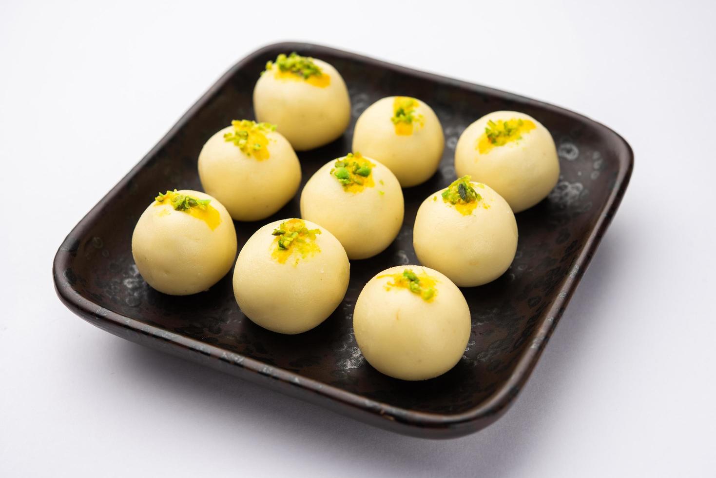 Sandesh or shondesh is a dessert, originating from the Bengal, India, created with milk and sugar photo