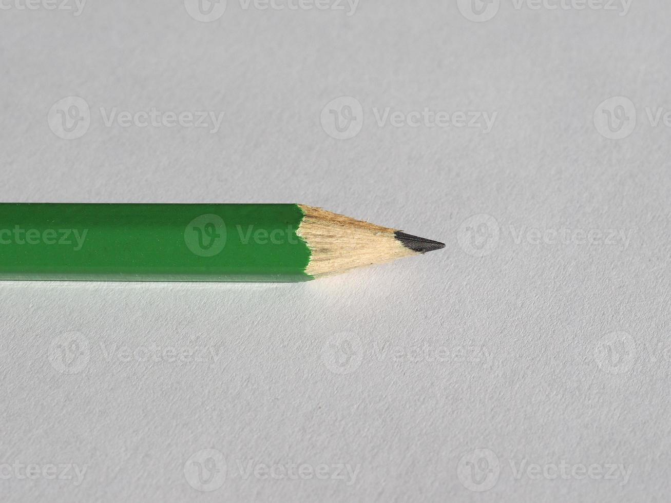 green pencil on paper sheet photo