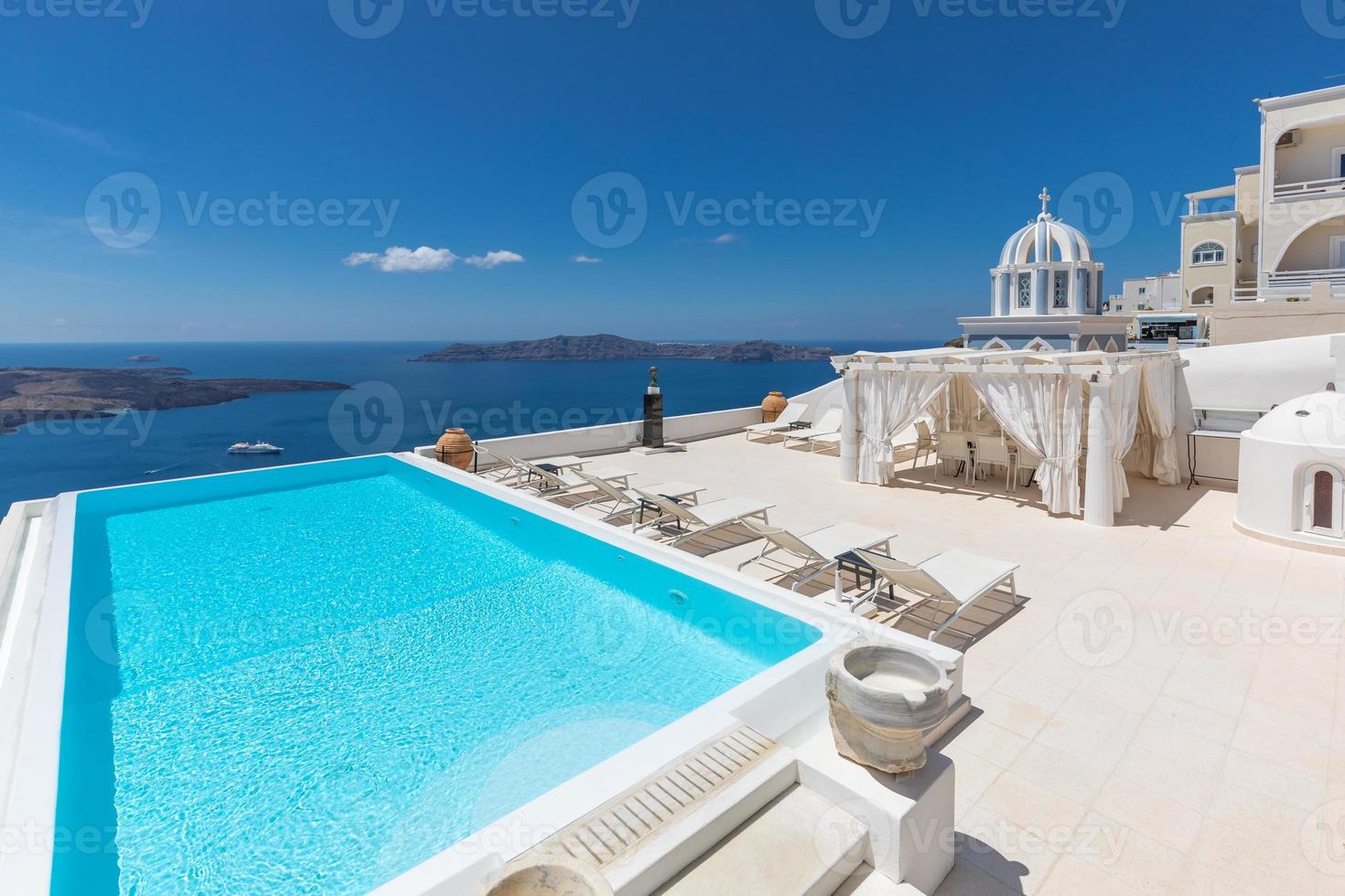 White architecture on Santorini island, Greece. Swimming pool in luxury hotel. Beautiful view, sky over blue sea. Summer vacation and holiday as travel destination concept, amazing tourism background photo