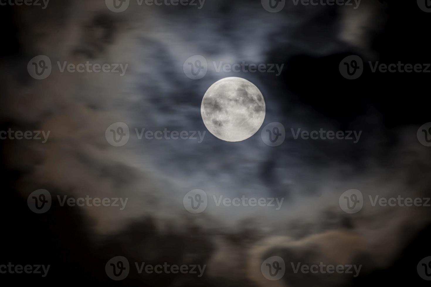 Close up picture of the shiny full moon with cirrostratus clouds photo