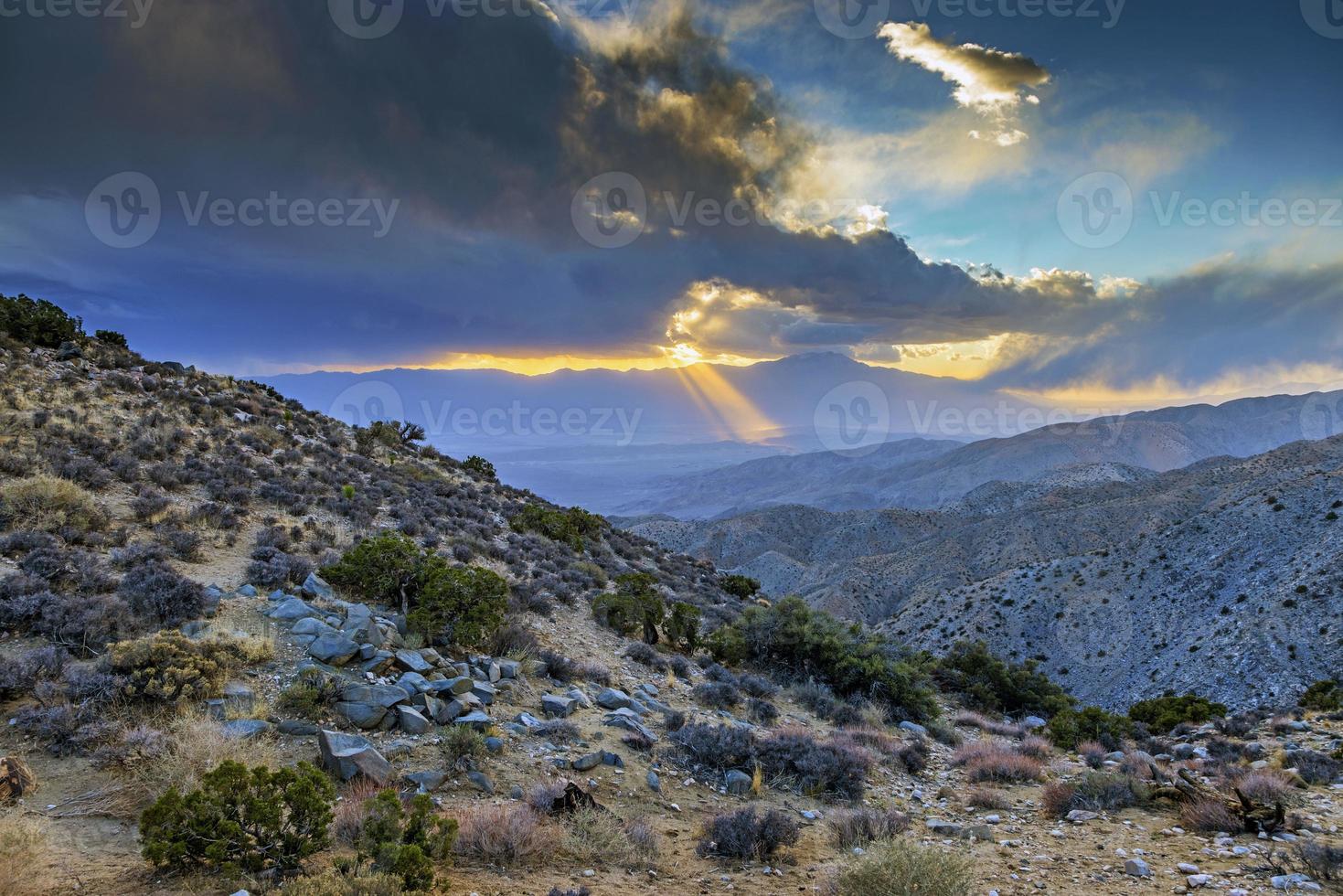 Image of a spectacular weather scene with impressive sun rays through a hole in the clouds photo