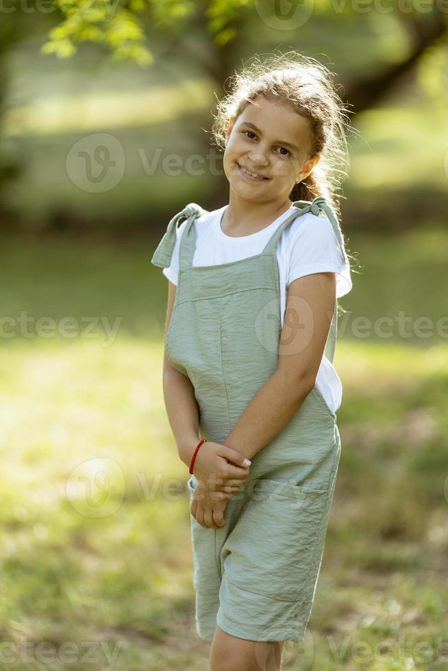 Cute little girl standing in the park photo