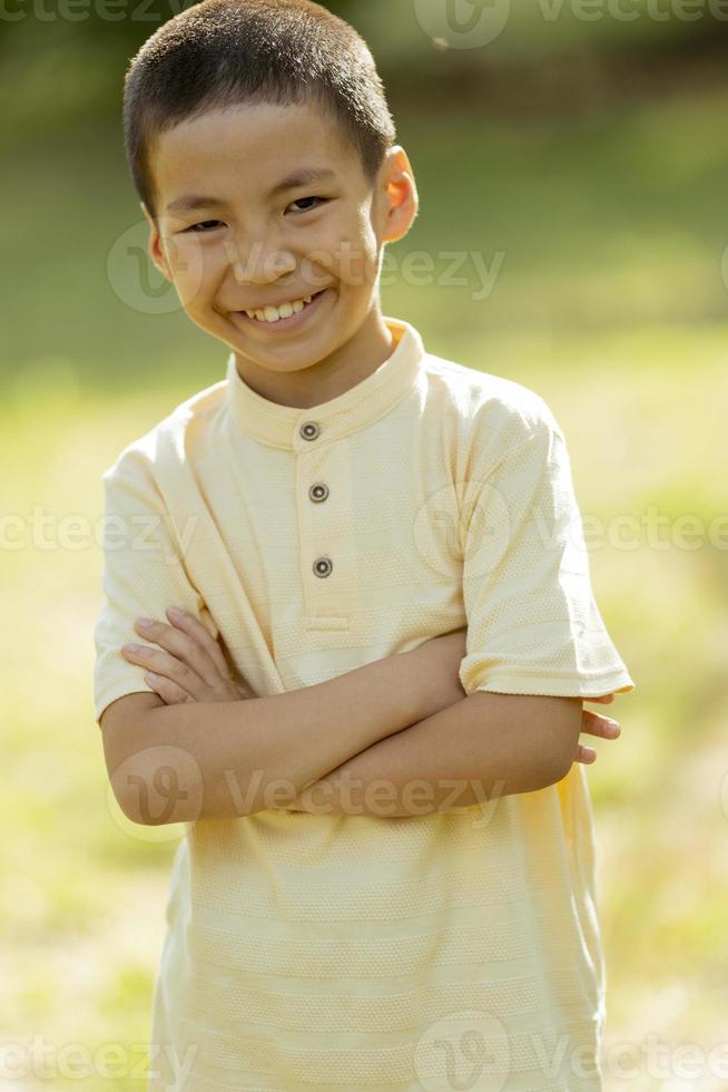 Little Korean boy standing in the park photo