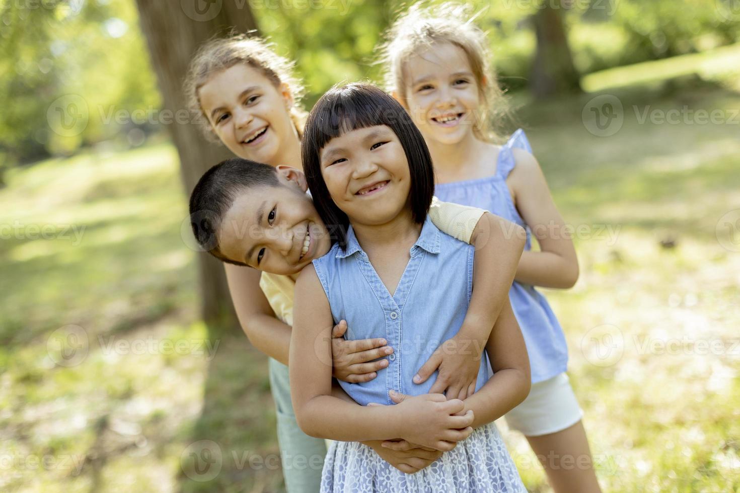 Group of asian and caucasian kids having fun in the park photo