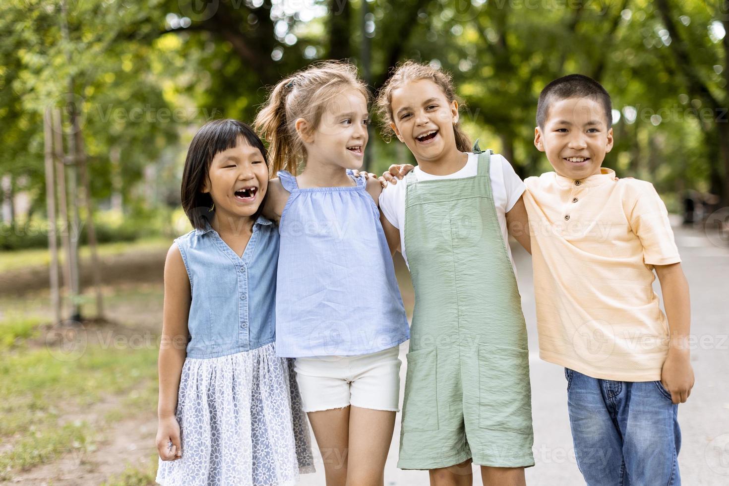 Group of asian and caucasian kids having fun in the park photo