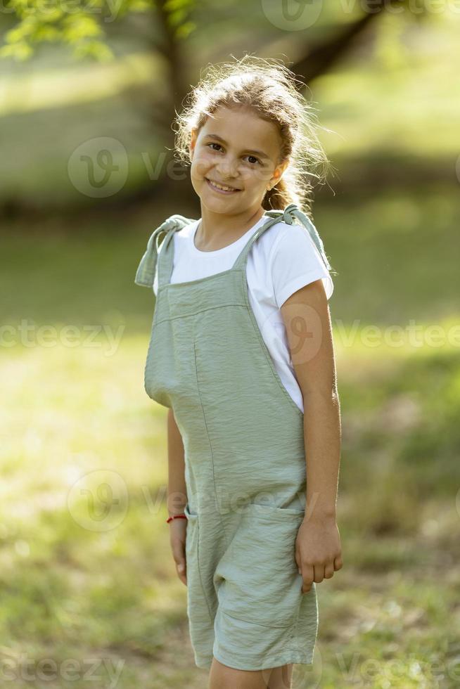 Cute little girl standing in the park photo