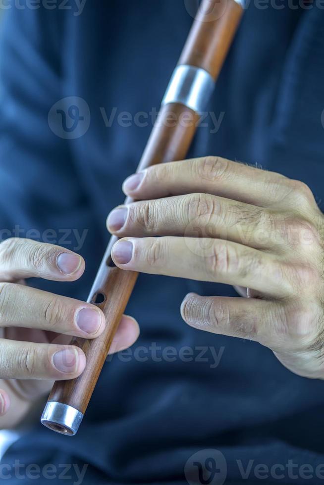 Wooden flute player photo