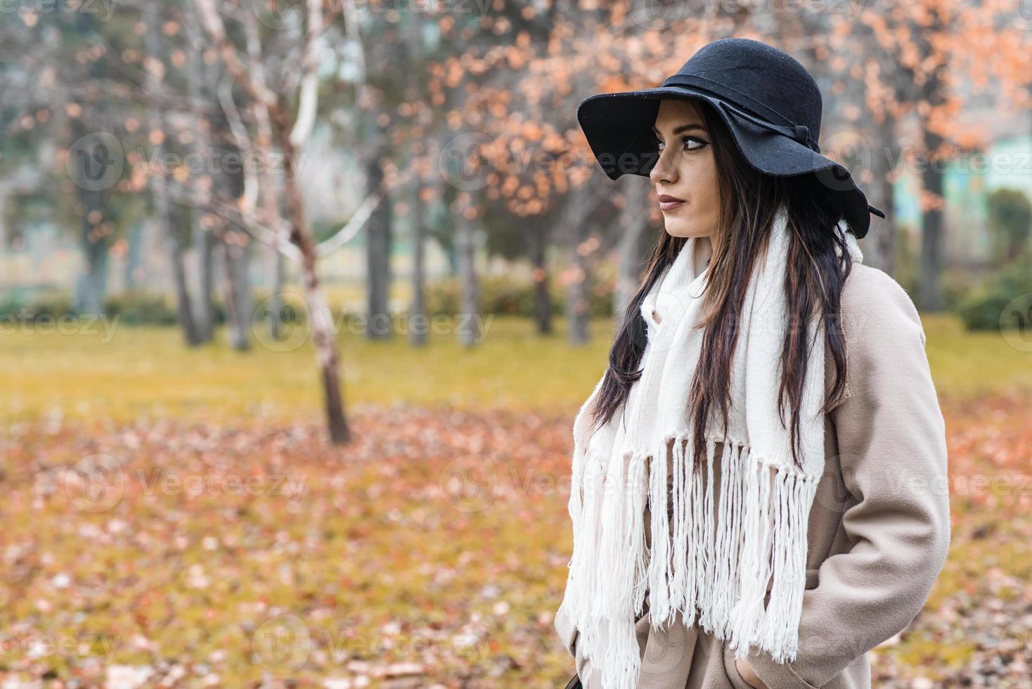 Young woman at autumn park photo