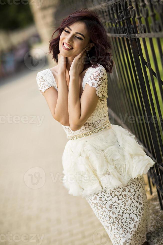 Young woman by the fence photo