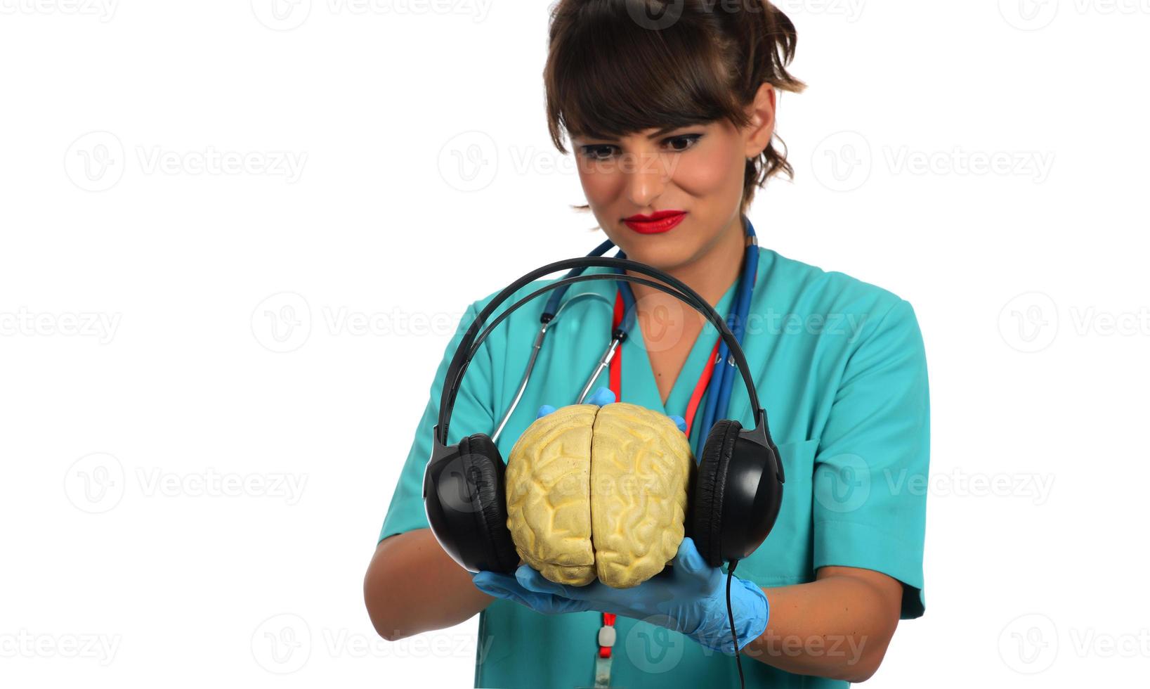 Female doctor holding a human brain model against white background photo