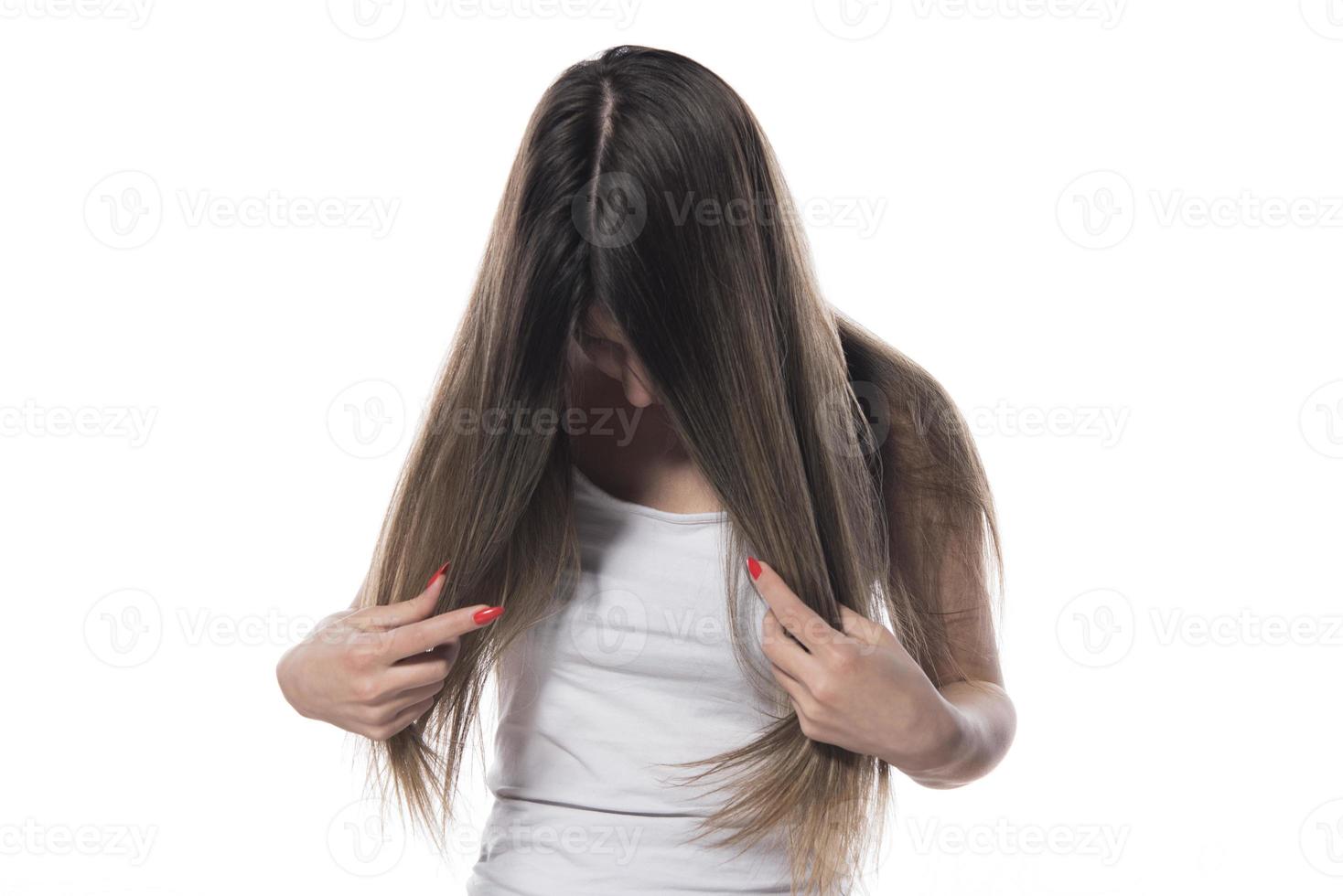 A young beautiful woman tied her hair with a rubber band photo