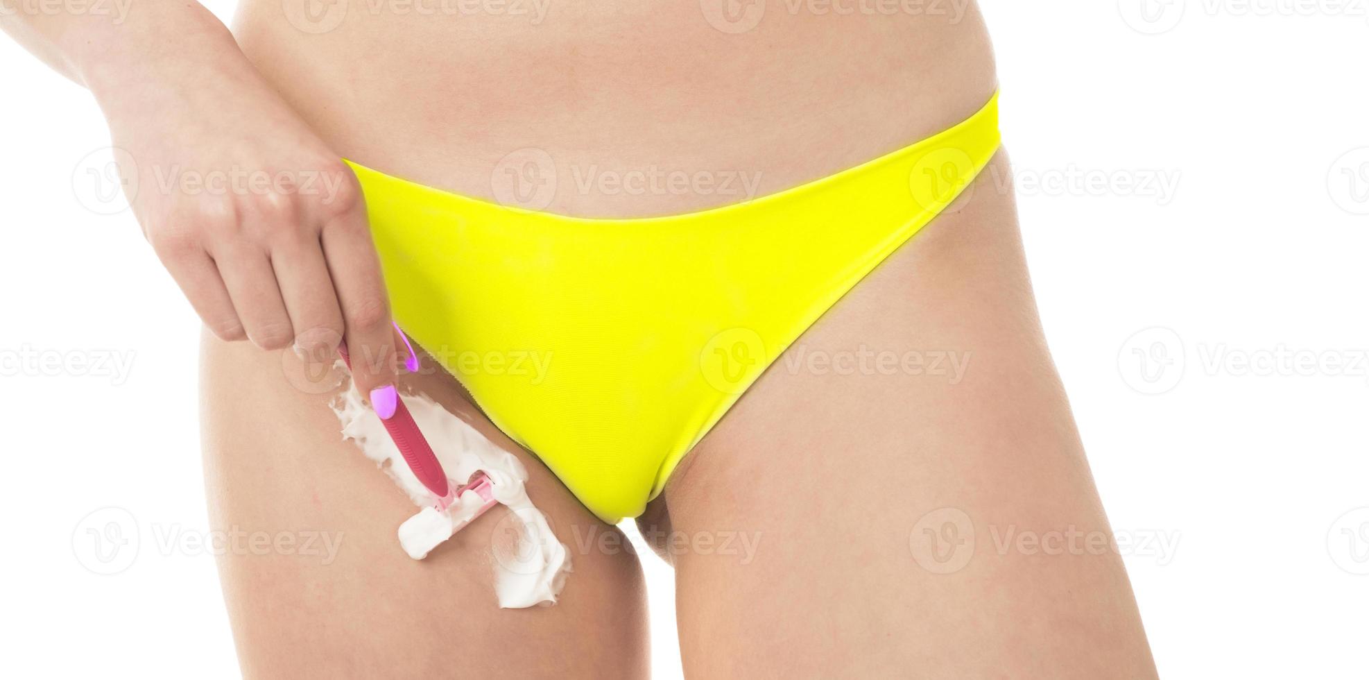 woman shaving her legs photo