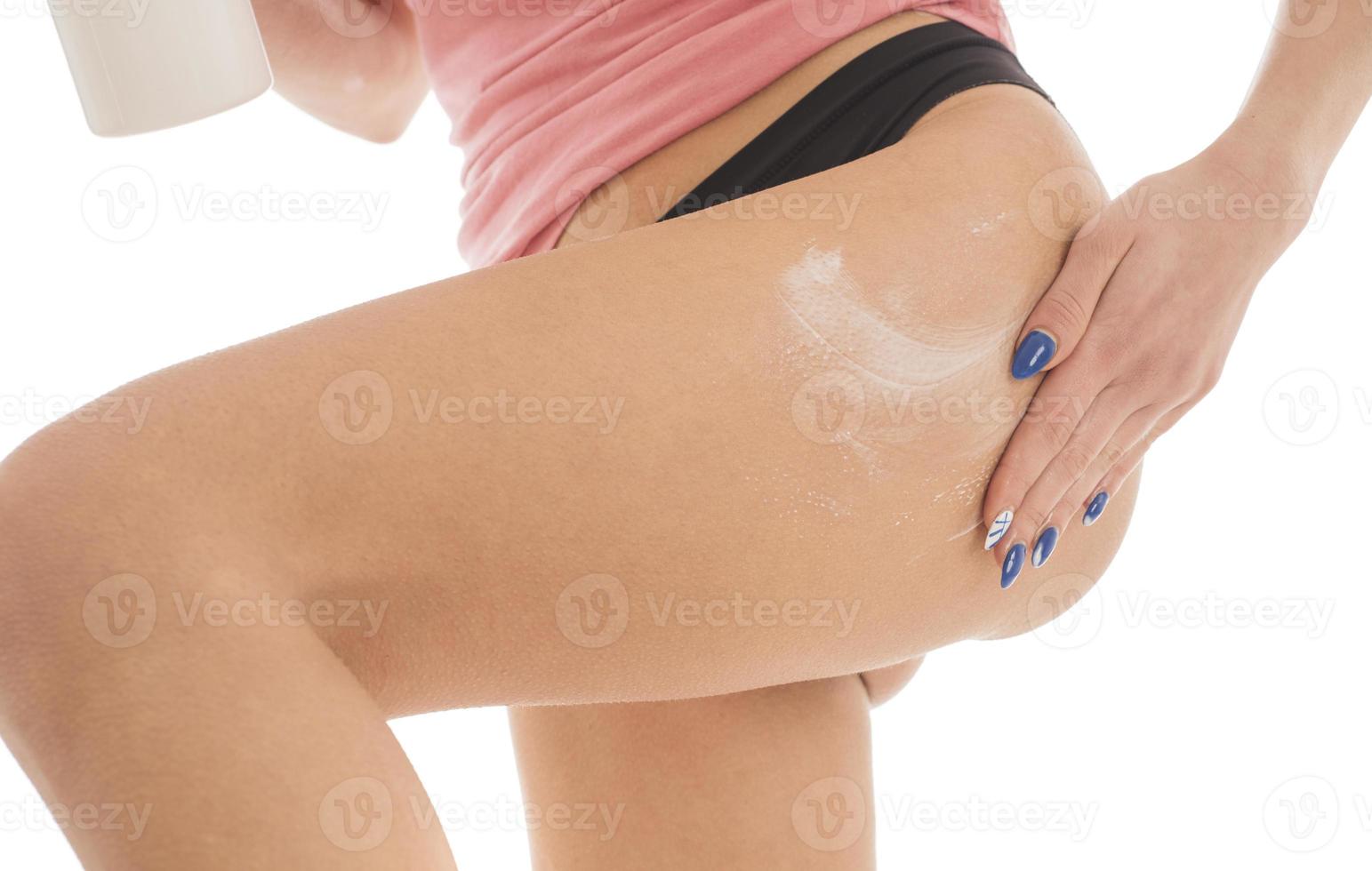 Body care. Unknown Woman applying cream on legs. Female applying anti cellulite cream photo