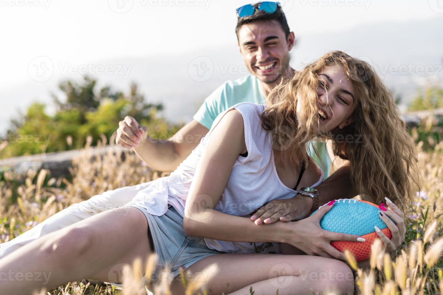 Couple playing American football on hot summer day. Couple playing Rugby photo shoot