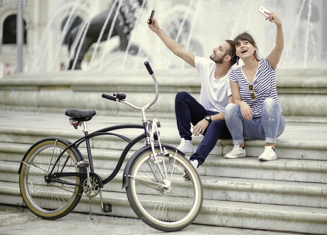 Couple of tourists having fun walking on city street at holiday - Happy friends laughing together on vacation - People and holidays concept photo