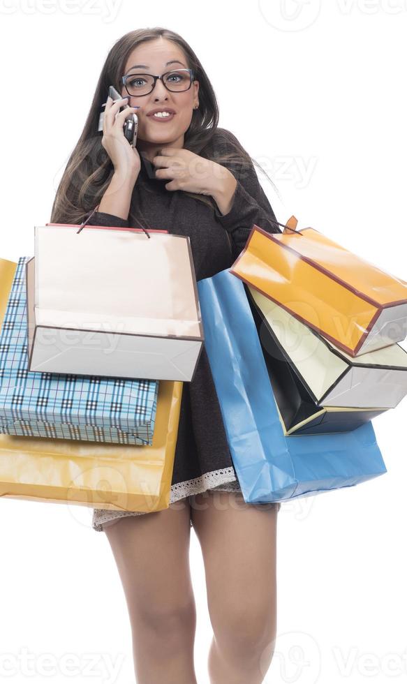 Happy woman with shopping bag on isolated studio background. photo