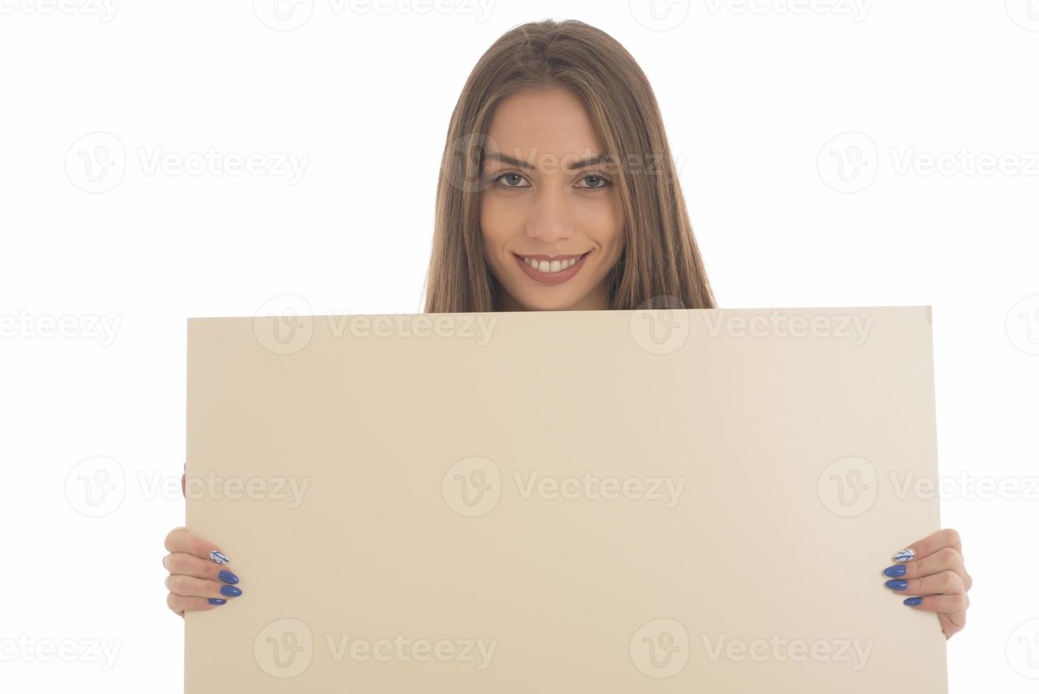 smiling girl holding blank sign board. studio portrait of young woman with sign card. isolated. photo