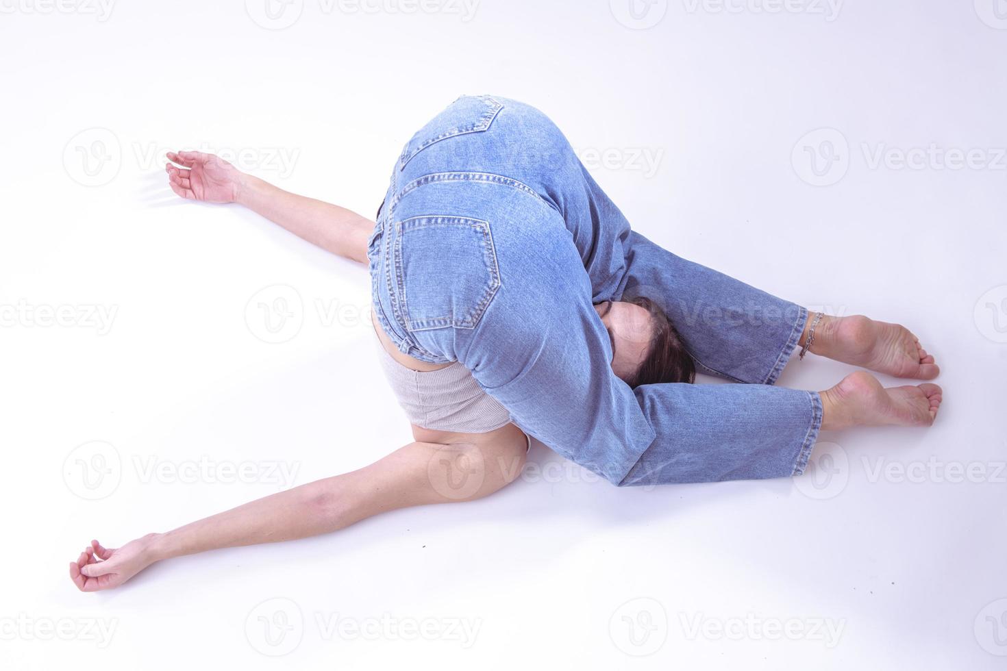 Portrait of beautiful young woman with athletic flexible body doing leg stretching. isolated photo