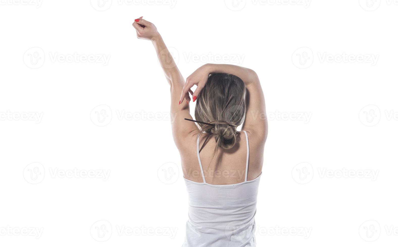 A young beautiful woman tied her hair with a rubber band photo
