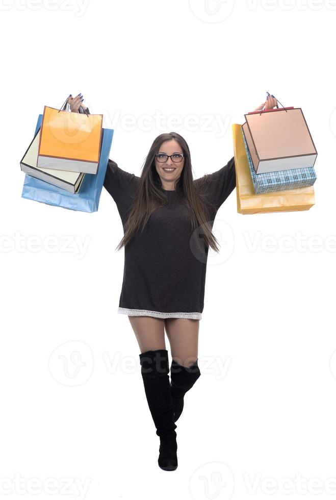 Happy woman full body portrait with shopping bag on isolated studio background. photo
