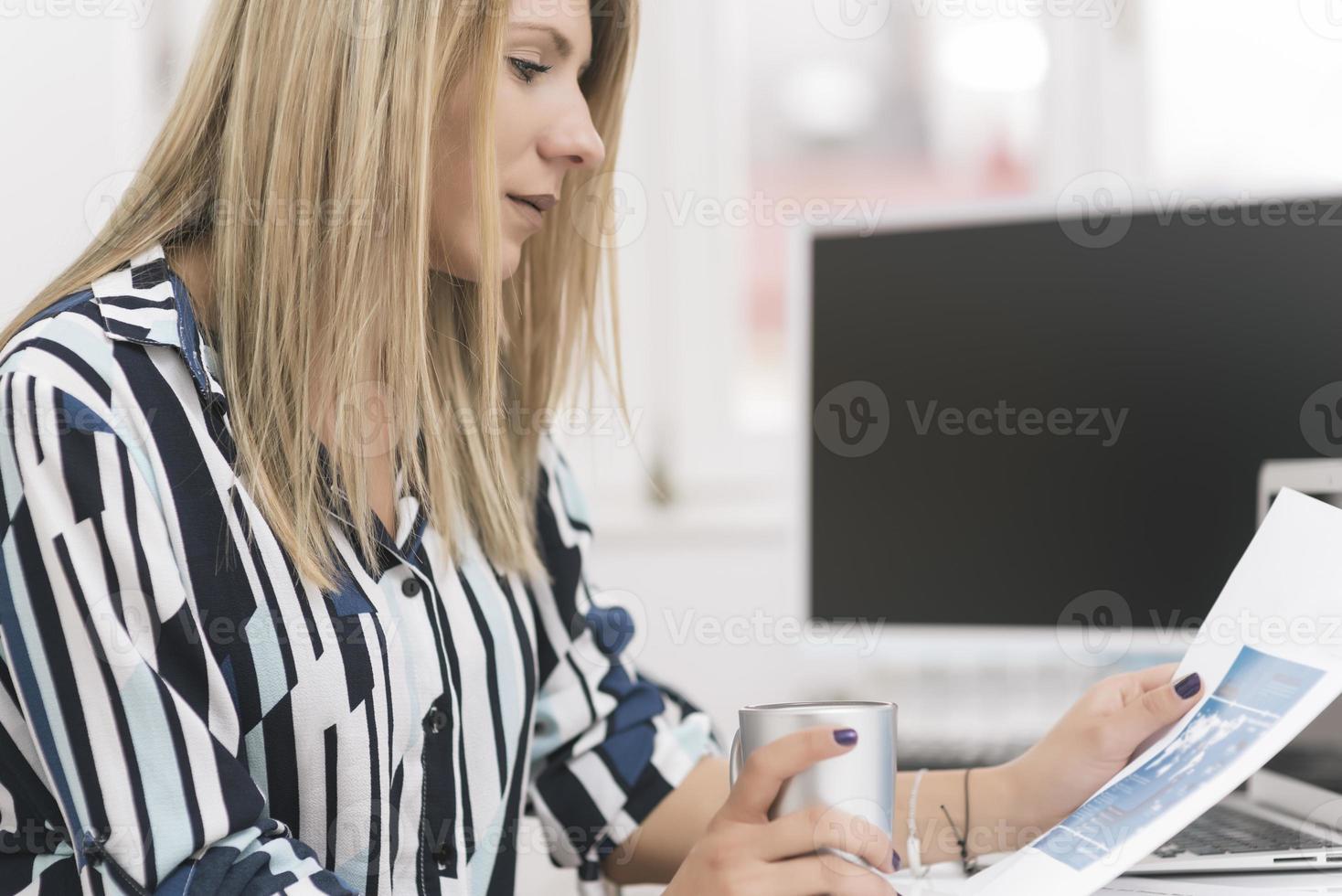 Business woman busy working on laptop computer at office. photo