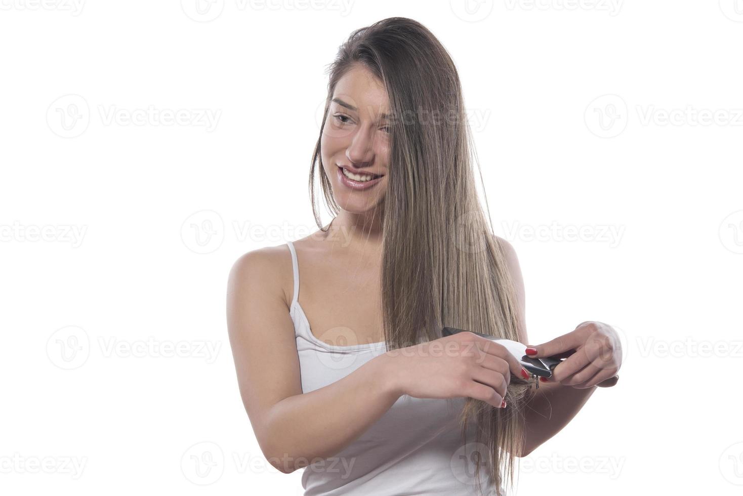 Young beautiful woman with long hair combing her hair in the morning. Hair care concept. photo