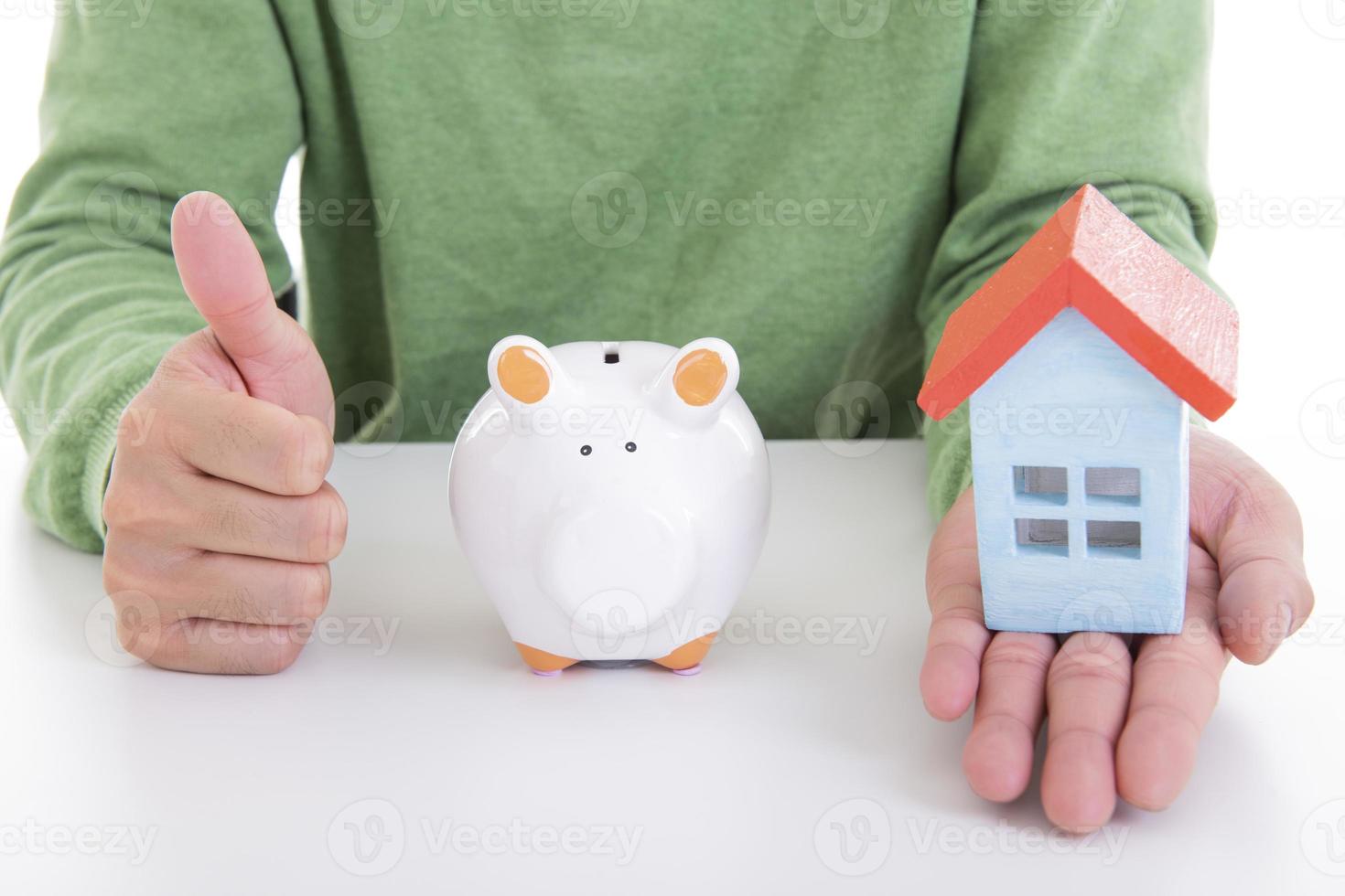 Asian man saving money in a piggy bank photo