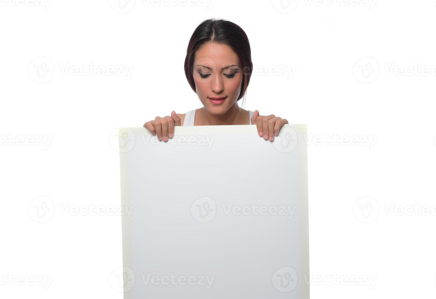 young smiling woman holding a blank sheet of paper for advertising photo