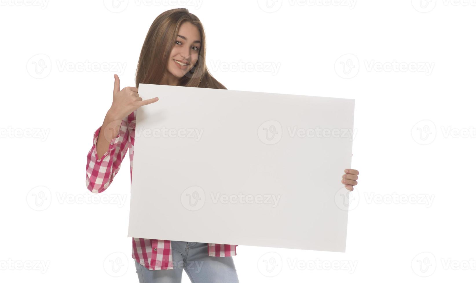 young smiling woman holding a blank sheet of paper for advertising photo