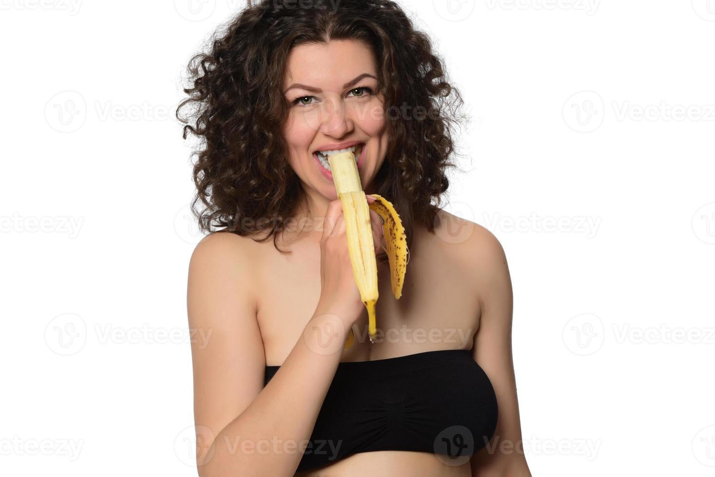 Young woman eating banana. photo