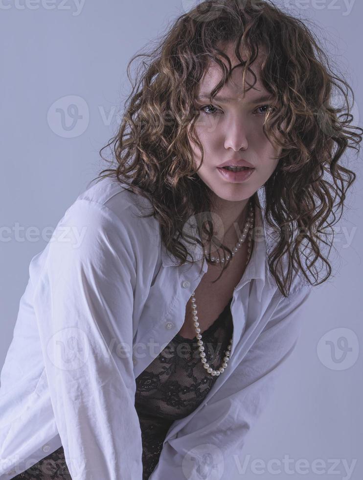 Beauty portrait of attractive woman wearing pearls and stylish fancy outfit photo