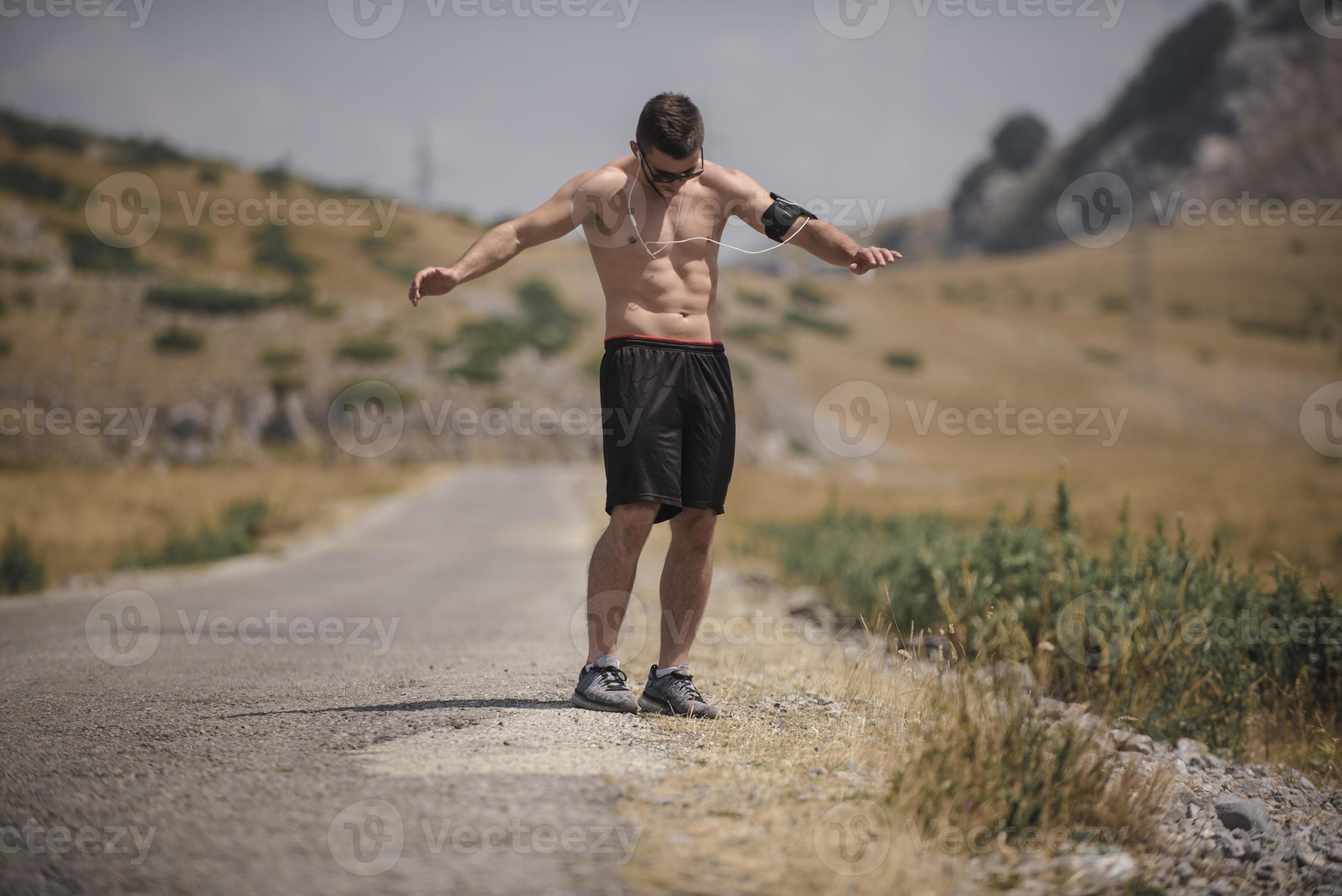 Athletic young man stretching after run in the nature. sport