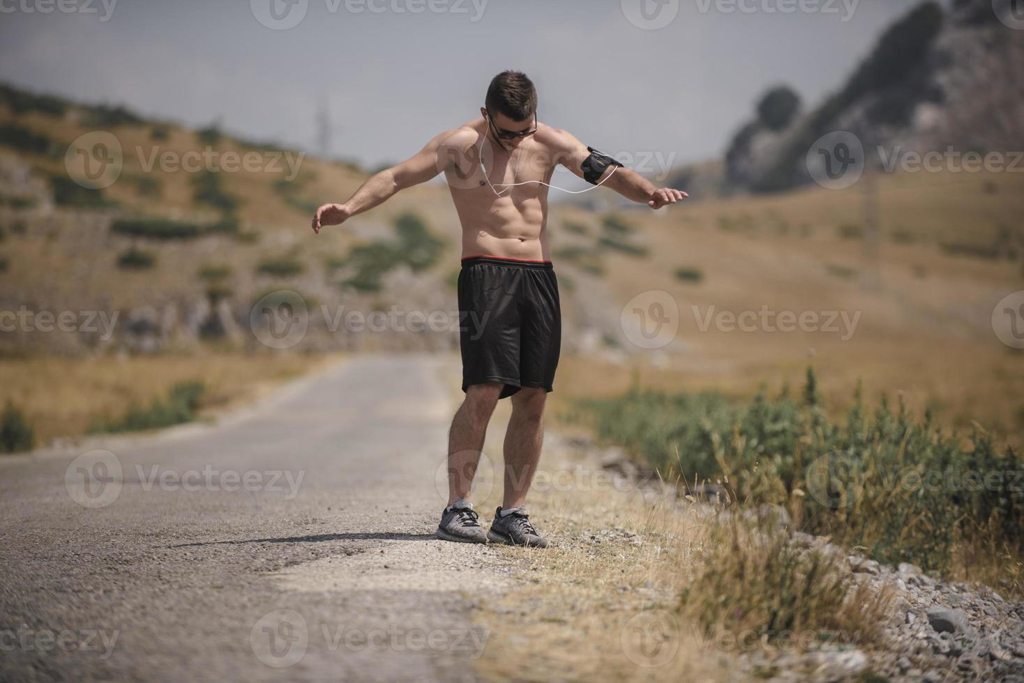 Athletic young man stretching after run in the nature. sport concept photo