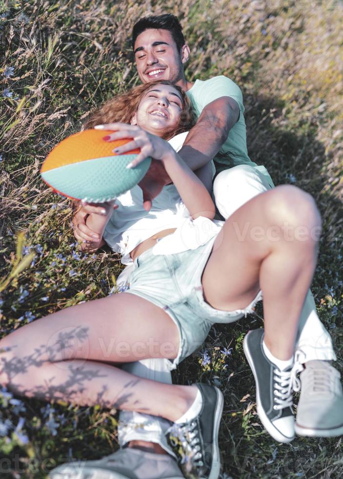 Couple playing American football on hot summer day. Couple playing Rugby photo shoot