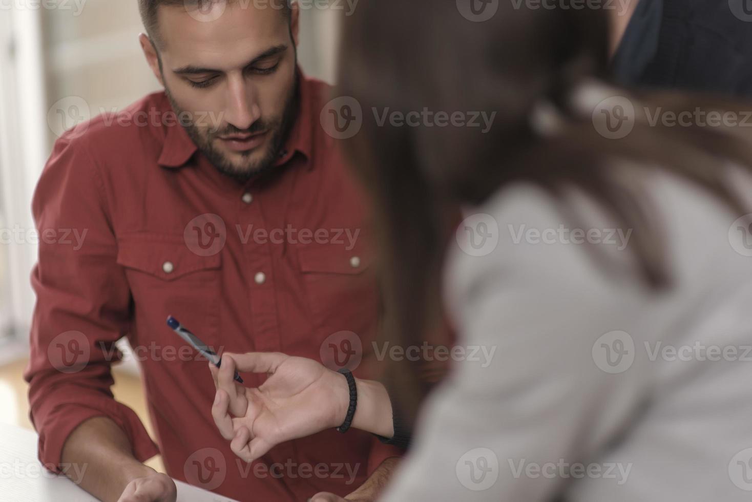 Two partnerships developing programming and coding technologies working on laptop and analyzing together. photo