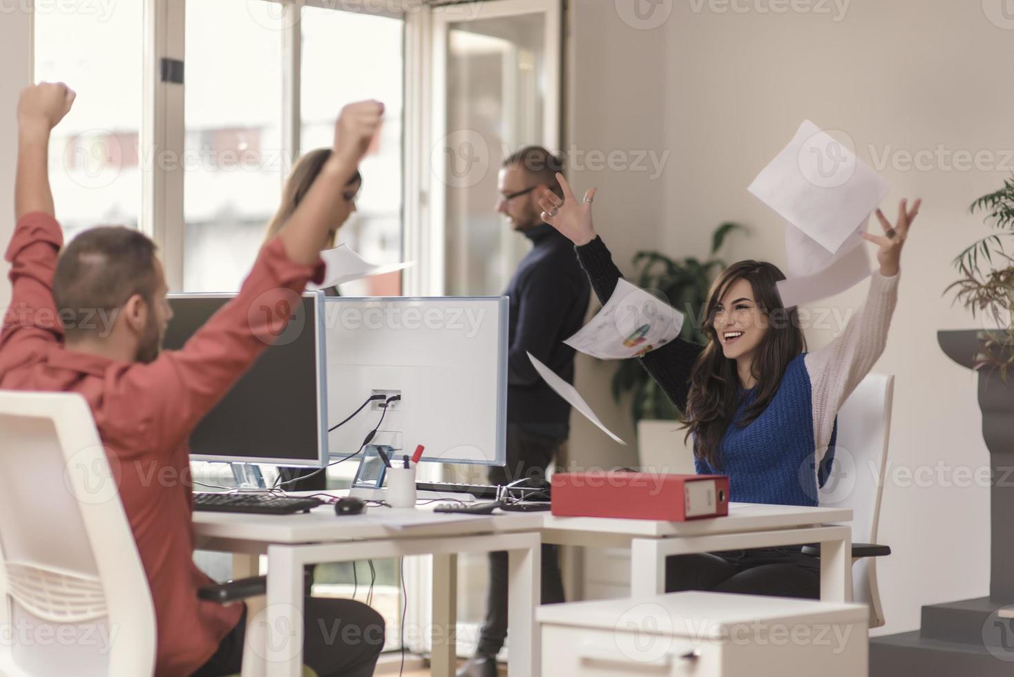 Two partnerships developing programming and coding technologies working on laptop and analyzing together. photo