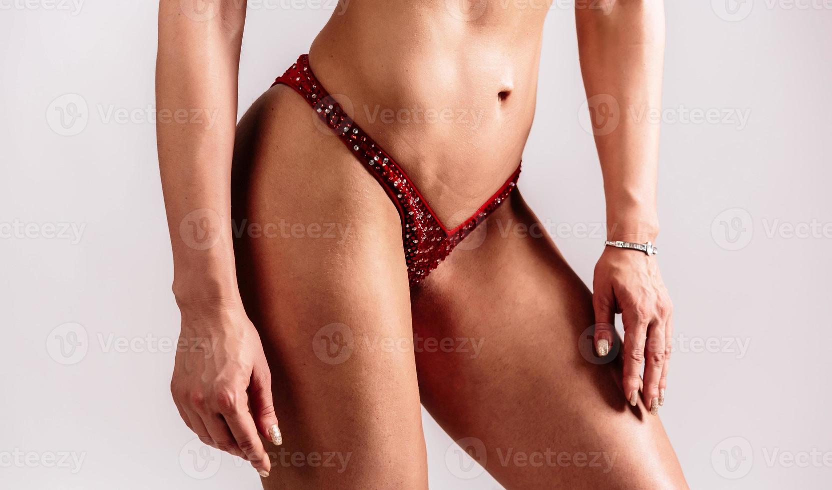 Woman with sportive slim body type in underwear that is in the studio. photo