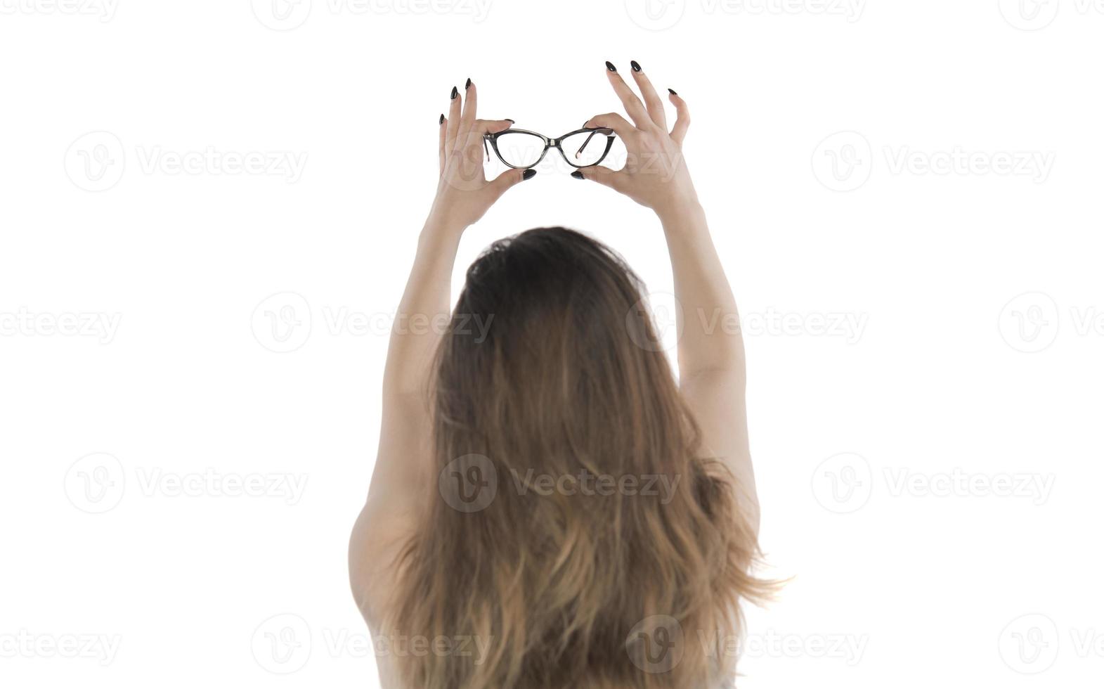 beautiful young woman holding eye glasses photo