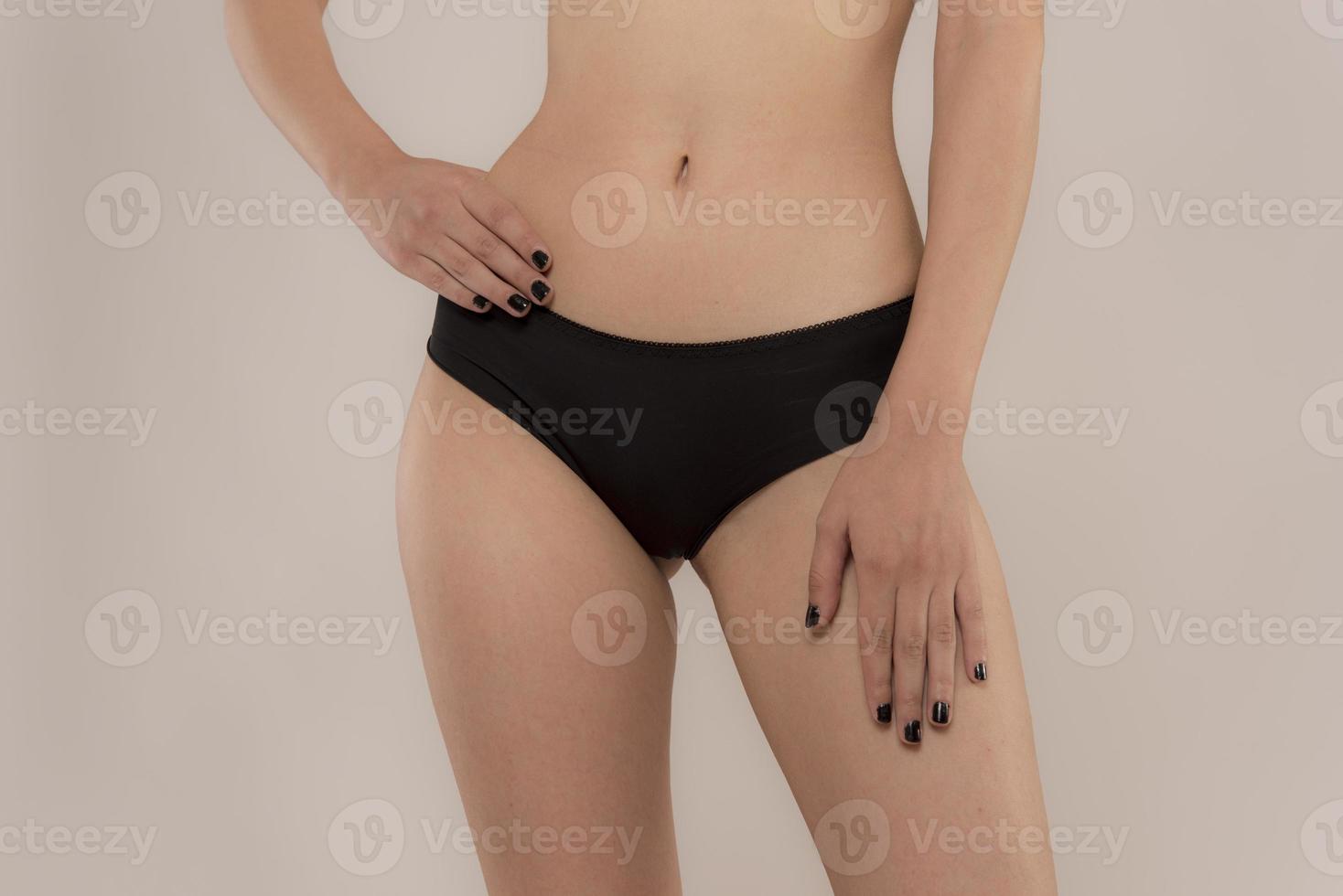 Woman with sportive slim body type in underwear photo