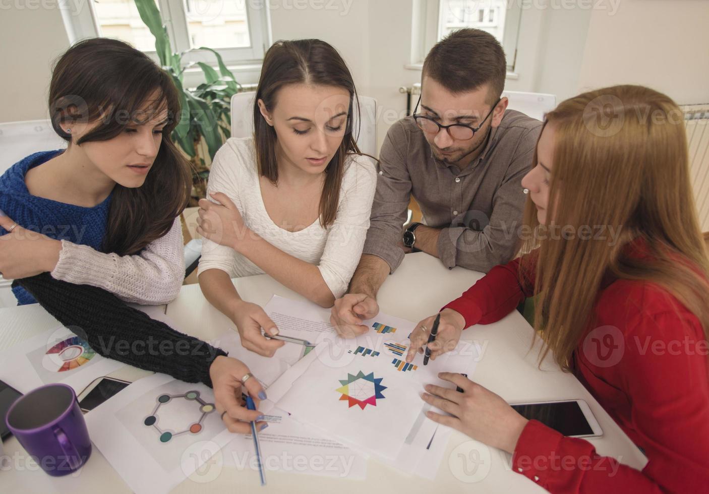 business woman explaining business matters to her team in a boardroom photo