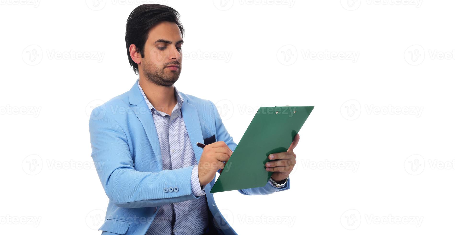 Arab businessman calculating finances holding paperwork on clipboard. isolated on white photo