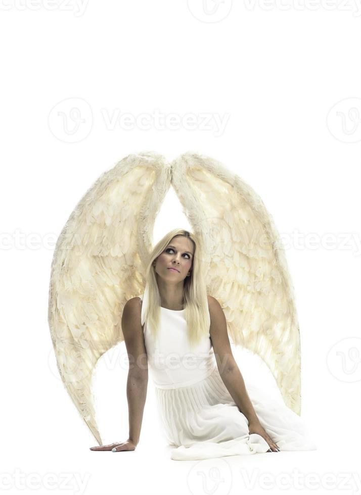 Portrait of beautiful blonde woman with angel's wings. Angel with long curly hair photo