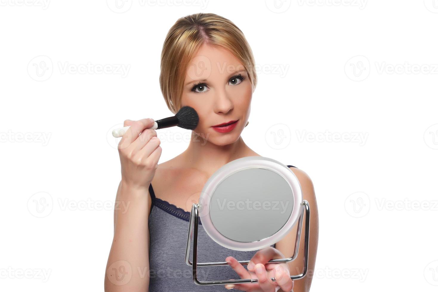 beautiful young smiling woman apply makeup with brush. isolated photo